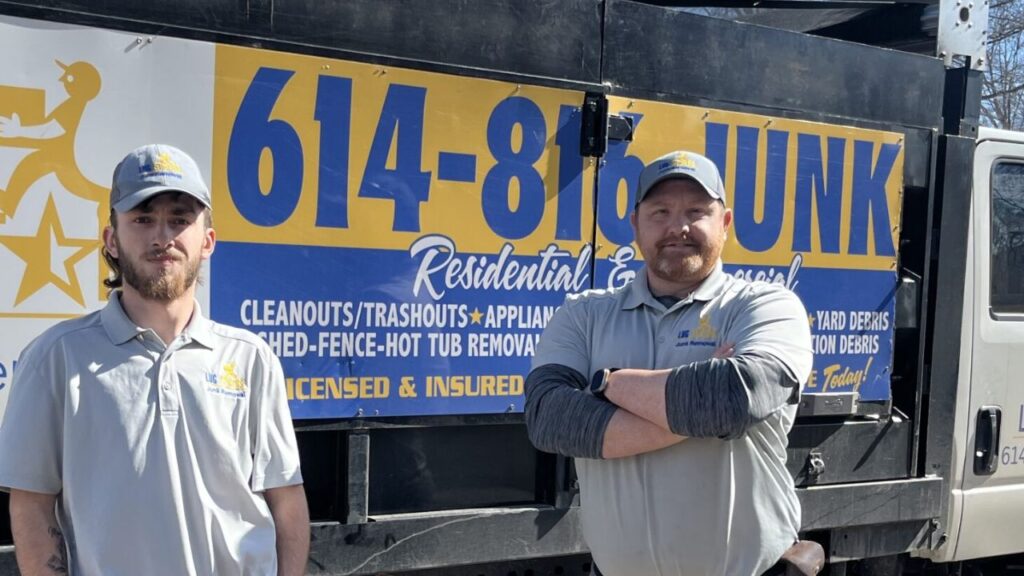 team in front of junk removal work trucks